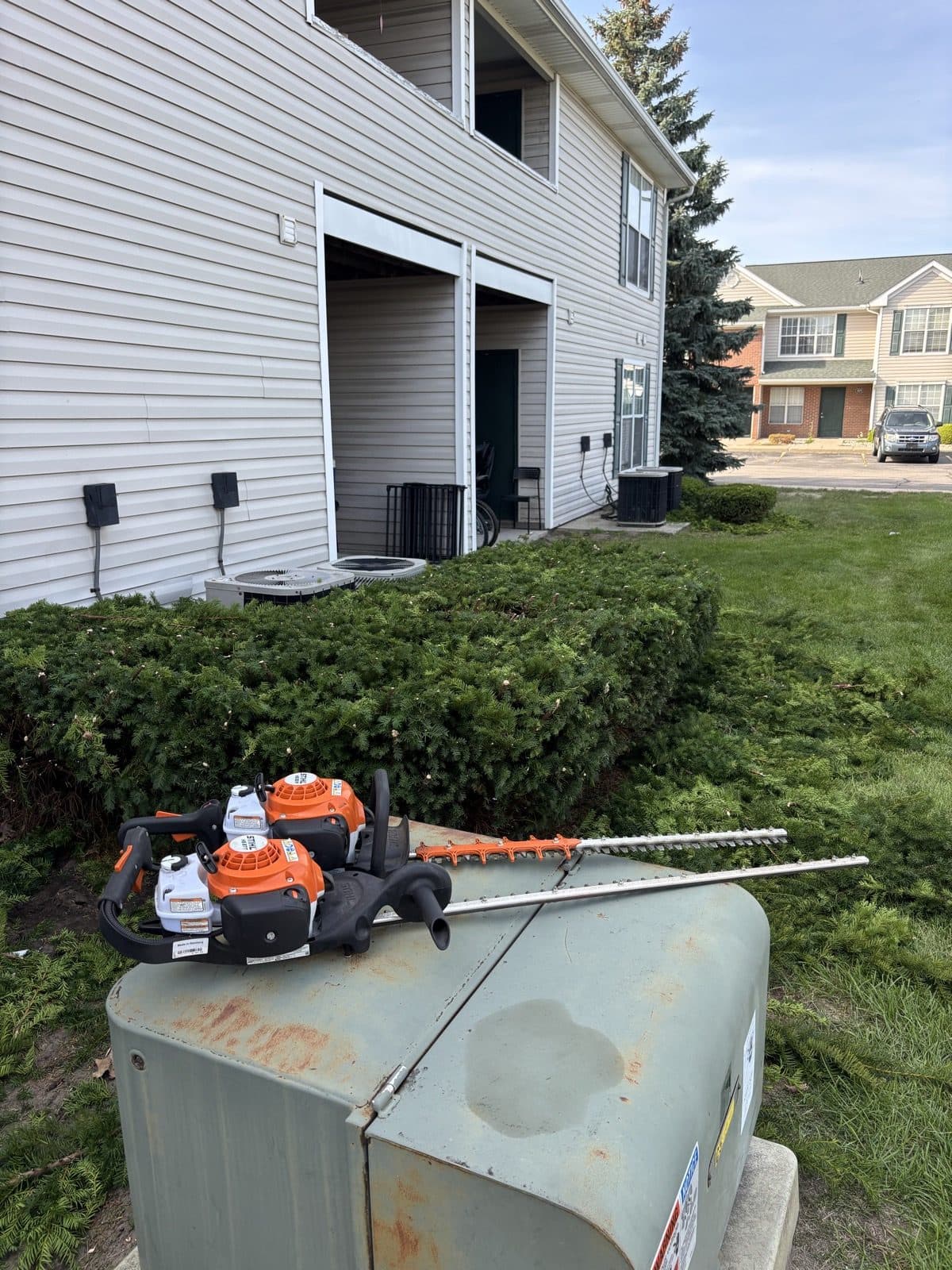 J. Molina Landscaping crew member working on a residential property beside the work truck